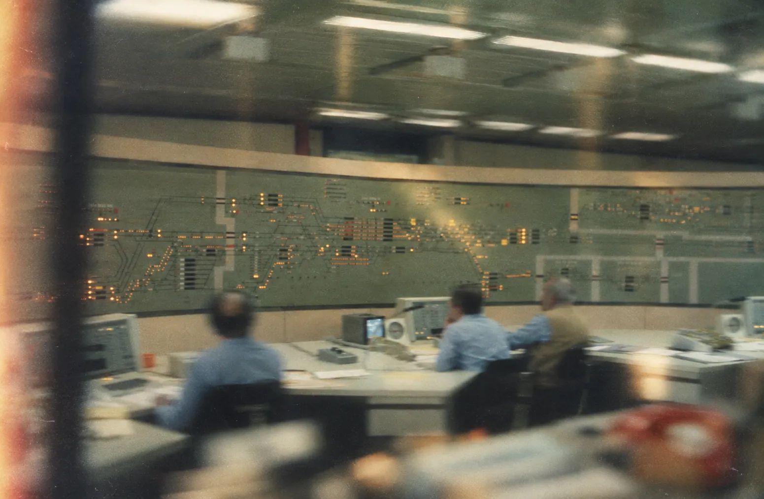 An operations control room: analysts watching a live schematic of the business